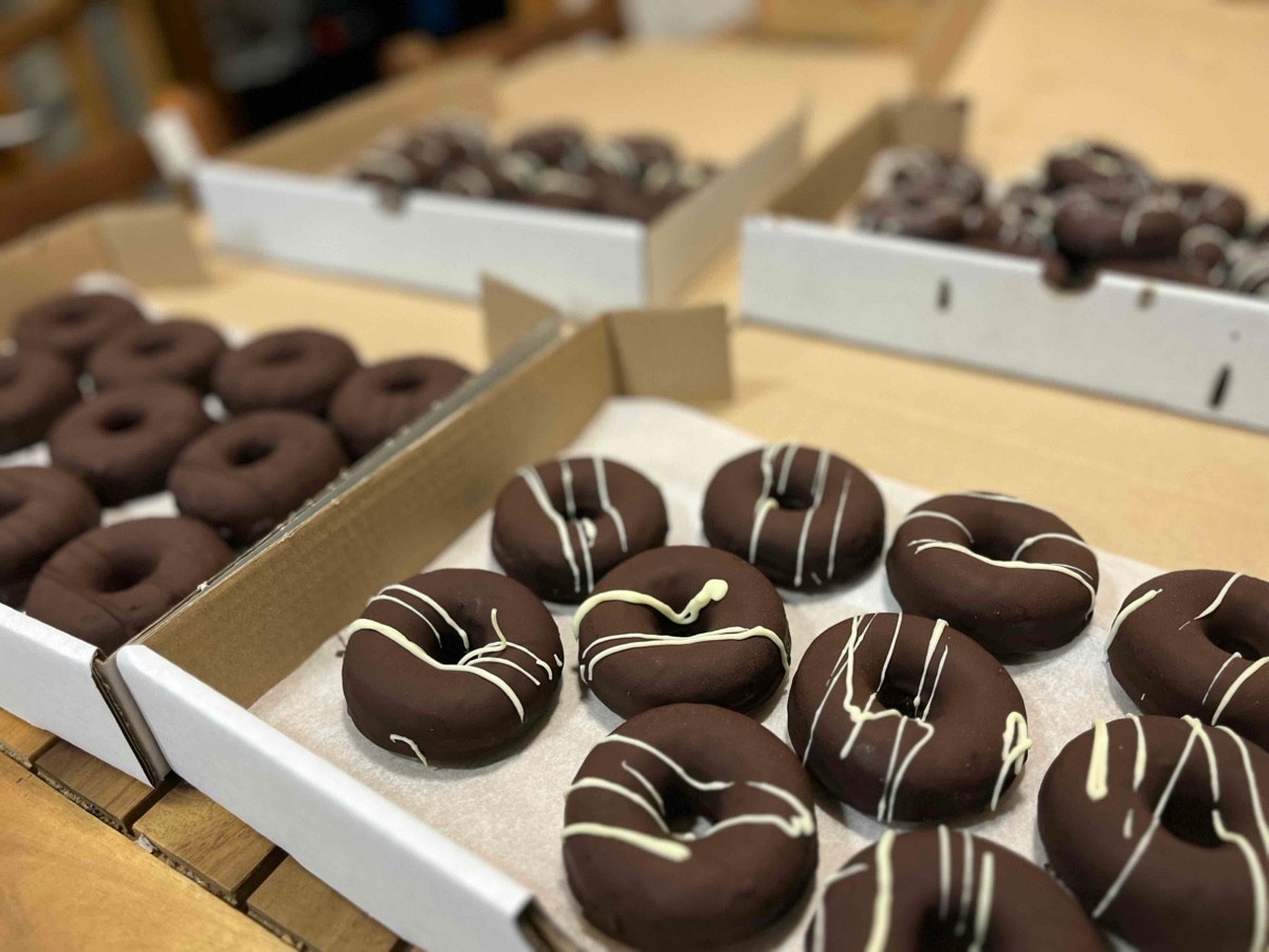 Cajas de donas recién cubiertas de chocolate